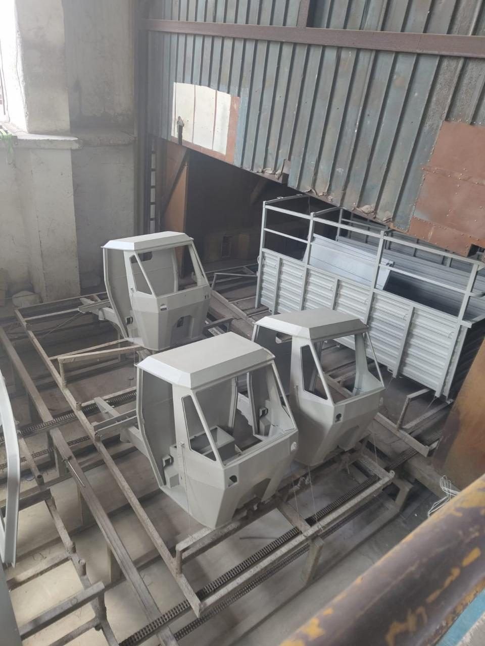 Cab shells lined up on the floor before paint